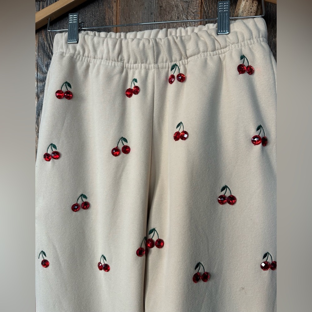 NEW Queen of Sparkles Tan Jeweled Cherry Sweatpants. Size XS.